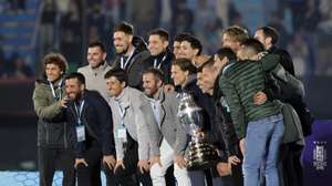 epa11590677 Uruguayan striker Luis Suarez, holding a trophy, poses with former soccer players during a tribute at a South American qualifiers match for the 2026 World Cup against Paraguay, at Centenario stadium in Montevideo, Uruguay, 06 September 2024.  EPA/Gaston Britos