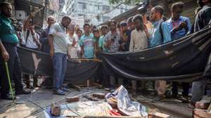 epa12539581 Local residents, police and journalists rush out into the streets after an eight-story building railing collapsed during an earthquake, in Dhaka, Bangladesh, 21 November 2025. According to the Directorate General of Health Services (DGHS), at least three people died and scores were injured on the morning of 21 November when a magnitude 5.7 earthquake struck near Narsingdi, east of Dhaka. Most casualties resulted from falling building railings and collapsing walls or roof sections.  EPA/MONIRUL ALAM