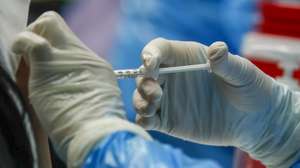epa09164664 A woman receives the second dose of the Sinovac COVID-19 vaccine at a school in Bangkok, Thailand, 28 April 2021. A group of workers considered to be high risk, linked to a cluster around entertainment venues received the second dose of the Sinovac COVID-19 as authorities continue their efforts to contain the third wave of COVID-19 infections.  EPA/DIEGO AZUBEL