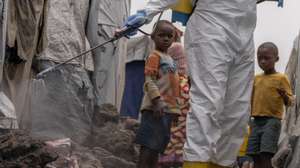 epa11559878 A Red Cross worker sprays chlorine as other Red Cross personnel raised awareness about mpox and hygiene among internally displaced people in the Don Bosco camps in Goma, Democratic Republic of Congo, 22 August 2024. The World Health Organization has declared the ongoing outbreaks of monkeypox (MPOX) in Congo and elsewhere in Africa a global emergency. Mpox causes fever, rash, and lesions all over the body, severe headaches, and fatigue.  EPA/MOISE KASEREKA