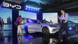 epa11086527 Journalists stand around a Build Your Dreams (BYD) Seal model during a launching ceremony of New Energy Vehicles (NEV) in Jakarta, Indonesia, 18 January 2024. BYD launched three NEVs Models: the BYD Seal, BYD Atto 3 and BYD Dolphin.  EPA/BAGUS INDAHONO