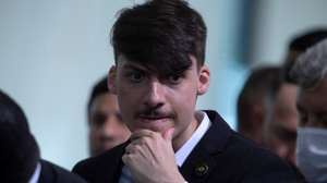 epa09034886 President Jair Bolsonaro's son, Jair Renan Bolsonaro, is seen during the ceremony of approval of the Central Bank Autonomy Law, in Brasilia, Brazil, 24 February 2021. Brazilian President Jair Bolsonaro renewed his Government with changes in two ministries and sanctioned a law that gives autonomy to the Central Bank, which is part of his objective of liberalizing the country's economy.  EPA/Joedson Alves