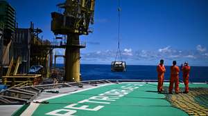 epa11696333 Employees on the P-51 platform of Brazilian oil company Petrobras in the Marlim Sul field, in the Campos Basin, off the northern coast of the State of Rio de Janeiro, Brazil, 31 October 2024 (issued 01 November 2024). Petrobras has launched a revitalization project to extend the life and increase production in the Campos offshore basin, which used to be its largest oil province and is now, just days away from the 50th anniversary of its discovery, considered a mature field.  EPA/Andre Borges