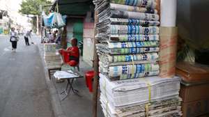 epa11247726 Newspapers are displayed for sale on a street in Phnom Penh, Cambodia, 28 March 2024. The Phnom Penh Post newspaper will stop printing its English and Khmer editions by 29 March, due to declining revenue. The newspaper will continue to be published online.  EPA/KITH SEREY