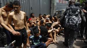 epa12487893 Rio de Janeiro Police officers detain a group of people during an operation in Rio de Janeiro, Brazil, 28 October 2025. At least twenty people were killed and fifty were arrested during a major police operation against Comando Vermelho, one of the most powerful organized crime gangs in Rio de Janeiro.  EPA/ANTONIO LACERDA