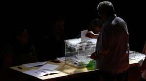 epa10659479 A man casts his vote during the local and regional elections at a polling station in Barcelona, Spain, 28 May 2023. Around 35.5 millions citizens are called to vote in the local and regional elections throughout Spain.  EPA/Alejandro Garcia