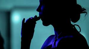 epa10729928 A person inhales a vape at a party in Caracas, Venezuela, 02 July 2023 (issued 06 July 2023). The order of the Venezuelan president Nicolas Maduro to evaluate the possibility of banning the sale of electronic cigarettes aroused the concern of sellers, who defend their use without opposing its regulation, and the expectations of the health sector, which supports the proposal for considering it preventive. The Pan American Health Organization (PAHO) stated that 'electronic cigarettes are the most common form of electronic nicotine delivery systems,' and that they 'threaten to upend decades of the fight against smoking.'  EPA/MIGUEL GUTIERREZ