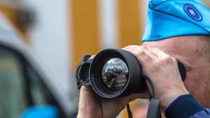 epa10581578 A member of FRONTEX looks through the monocular prior to the official launch ceremony of the FRONTEX Joint Operation in Skopje, Republic of North Macedonia, 20 April 2023. It is planned that in 2023, FRONTEX will deploy more than 100 officers, patrol vehicles and special equipment on the Macedonian-Greek border, which will significantly increase the capacity to detect illegal activities along the border, while respecting and protecting the basic rights of every person.  EPA/GEORGI LICOVSKI