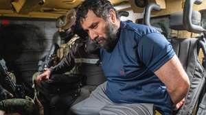 epaselect epa12198026 Drug trafficker Jose Adolfo Macias Villamar 'Fito' (R) is guarded as he is moved in Guayaquil, Ecuador, 25 June 2025. 'Fito' arrived at the Guayaquil Air Base after being captured in the city of Manta, and will be held in the maximum security prison La Roca.  EPA/MAURICIO TORRES
