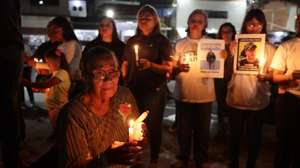 epa12775050 Relatives of political prisoners hold signs and candles during a vigil outside of El Rodeo I prison in Zamora, Venezuela, 24 February 2026. The Law for Democratic Coexistence was passed by the National Assembly on 19 February 2026 to enable the release of detainees.  EPA/RONALD PENA R