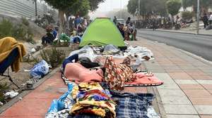 epa13210871 Migrants sleep rough along a street in Ceuta, Spain, 04 September 2026. Spain has been facing a migration crisis since late July 2026, when tens of thousands of people crossed from Morocco into the North African enclave of Ceuta.  EPA/REDUAN