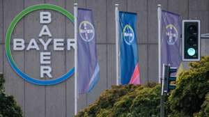 epa12286116 Flags fly in front of a sign with the Bayer logo at the headquarters of Bayer AG's Pharmaceuticals division in Berlin, Germany, 06 August 2025. Bayer published their half-year financial report on 06 August 2025.  EPA/CLEMENS BILAN