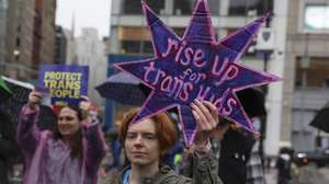 epaselect epa12641457 A person holds a sign that reads 'rise up for trans kids' during a rally in support of transgender rights ahead of US Supreme Court arguments on transgender youth participation in sports at Union Square in New York, New York, USA, 10 January 2026. The US Supreme Court is scheduled to hear oral arguments on 13 January for 'West Virginia v. B.P.J.' and 'Little v. Hecox', concerning state laws banning trans girls from sports in public schools.  EPA/SARAH YENESEL