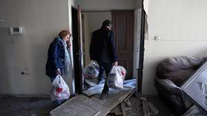 epa12873504 An Iranian couple collects their belongings from their damaged apartment in a residential building situated next to Khorasaniha Synagogue in Tehran, Iran, 07 April 2026. A joint Israeli and US military operation continues to target multiple locations across Iran since the early hours of 28 February 2026.  EPA/ABEDIN TAHERKENAREH