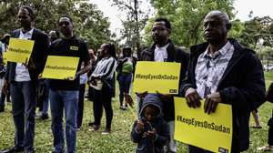 epa12891685 Some of the Sudanese civilian refugees and human rights activists hold placards with the wordings, 'KeepEyesOnSudan' during a commemorative gathering dubbed 'Under the Neema (Tree)' to mark the third anniversary since the war in Sudan started, organized by the Amnesty International at the Freedom Corner in Nairobi, Kenya, 15 April 2026. According to an Amnesty International report, since 2023, tens of thousands of people have been killed and nearly 14 million have been displaced. Both sides of the conflict are violating human rights resulting in mass civilian casualties, gender-based violence and a humanitarian catastrophe that has arisen from aid being blocked.  EPA/DANIEL IRUNGU
