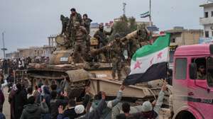 epa12656323 People celebrate the entry of Syrian army forces into the Deir Hafer area after the withdrawal of the Kurdish-led Syrian Democratic Forces (SDF), in Deir Hafer, eastern Aleppo countryside, Syria, 17 January 2026.  EPA/AHMAD FALLAHA