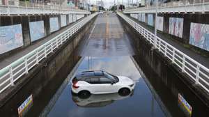 epa13168497 A car is blocked in a flooded underpass in Kamagaya, Chiba prefecture, Japan, 14 August 2026. At least four people have died in Chiba prefecture following record-breaking torrential rainfall that triggered widespread flash floods and power outages across the region, according to the Chiba Prefectural Disaster Management Headquarters.  EPA/JIJI PRESS JAPAN OUT EDITORIAL USE ONLY/