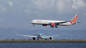 epa12527205 An Air India airlines lands at the San Francisco International Airport (SFO) as seen from Bayfront Park in Burlingame, California, USA, 14 November 2025. Officials warned it may take days for airports to get back up to speed despite President Donald Trump signing a bill to end the government shutdown on 12 November.  EPA/JOHN G. MABANGLO