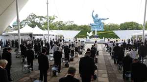 epa09406890 People observe a moment of silence during a ceremony at Peace Park in Nagasaki, southern Japan, 09 August 2021. Nagasaki marks the 76th anniversary of the atomic bombing on 09 August 1945, as related events are either canceled or scaled down this year to avoid the spreading of the coronavirus and COVID-19 disease pandemic.  EPA/JIJI PRESS JAPAN OUT EDITORIAL USE ONLY/  NO ARCHIVES