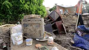 epa07794272 An old muddy tv post and a box of local Nutella salavaged from a house following heavy floods, in Geli, some 40 km north of Khartoum, Sudan, 25 August 2019. According to local witnesses, Geli inhabitants were surprised by the sudden and heavy arrival of water in their streets. Heavy rain waters coming from higher grounds around them reached them in the form of a flash flood. Geli dwellers said that some 600 mostly mud houses had been destroyed. According to aid agencies reports, floods have affected some 190,000 people in various states of Sudan, reportedly killing 60.  EPA/AMEL PAIN