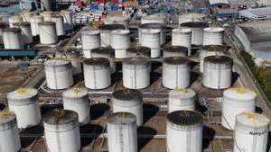 epa12889034 An image made with a drone shows oil gas and fuel storage units at the Navigator Terminal in Grays, Britain, 14 April 2026. Oil prices have risen above 100 US dollars a barrel again as the US Navy begins a blockade of the Strait of Hormuz following the collapse of ceasefire negotiations between Iran and the United States. Meanwhile, leasing of electric vehicles has surged across Europe amid rising petrol prices linked to the Iran war.  EPA/NEIL HALL