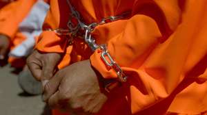 epa08421138 A Yemeni former Guantanamo detainee dressed in orange prison uniforms takes part in a rally demanding the release of Yemeni detainees from the US-run Guantanamo detention center, outside the US embassy in Sanaa, Yemen, 16 April 2013 (reissued 14 May 2020). Orange is the color that envelopes tires that burn in the streets during social unrest and the flames that turn structures to ash during four-alarm fires. It is the color of the lava that flows down the facades of volcanoes and the color of fireworks that illuminate the skies as people gather to celebrate the new year.  EPA/YAHYA ARHAB  ATTENTION: This Image is part of a PHOTO SET
