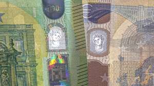 epa07589196 An image showing the new 100 euro and 200 euro banknotes with their security details visible during their presentation by the Deutsche Bundesbank, German central bank, in Frankfurt Main, Germany, 21 May 2019.  EPA/ARMANDO BABANI