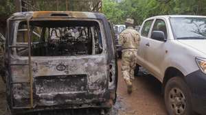 epa04880198 A soldier from Mali surveys the scene of a terrorist attack at hotel Byblos in Sevare, Mali, 11 August 2015. Twelve people comprising of five terrorists, five Mali soldiers and two foreigners were killed in a hostage siege at the hotel Byblos on 07 August 2015. Terrorists seiged the Byblos resulting in Mali government troops having to storm the hotel. One of the foreign victims was reported to be a member of the UN peacekeeping mission (MINUSMA) and one was from South Africa. This attack is the third assault in a week. Mali is still trying to restore stability following the advance of Al-qaeda linked fighters which led to a war in 2013. A peace deal agreed to in June 2015 was hoped to end years of unrest and ethnic divisions.  EPA/STR