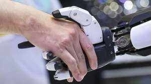 epa12091103 People shake hands with 'Mornine,' a Chery Automobile humanoid robot sales assistant, during the Malaysia Autoshow 2025 in Kuala Lumpur, Malaysia, 10 May 2025 (issued 11 May 2025). The Chery AiMOGA robot, nicknamed 'Mornine,' is a 1.66-meter-tall humanoid sales assistant made by Chery. Originally a virtual character for young people, it is now a physical robot with advanced sensors, flexible limbs, and a silicone face with realistic facial expressions. These robots use open-source AI models to interact with people and will be used in Chery showrooms for customer service in the future.  EPA/FAZRY ISMAIL