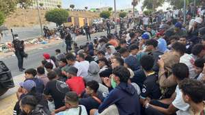 epa13201921 Migrants wait outside the Loma Colmenar temporary migrant shelter in Ceuta, Spain, 31 August 2026. Spain faced a massive migration crisis after thousands of people crossed into the North African enclave of Ceuta from Morocco in late July 2026.  EPA/Reduan