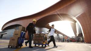 epa12906474 Workers walk outside the 2026 Beijing International Automotive Exhibition in Beijing, China, 22 April 2026. 2026 Beijing International Automotive Exhibition will be held from  24 April to 03 May 2026.  EPA/WU HAO