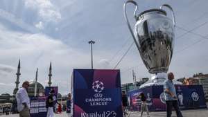 epa10679827 People walk around a huge model of the UEFA Champions League trophy backdropped by the Taksim Mosque at the Taksim Square in Istanbul, Turkey, 08 June 2023. Manchester City will play Inter Milan in the UEFA Champions League final at the Ataturk Olympic Stadium in Istanbul on 10 June 2023.  EPA/ERDEM SAHIN