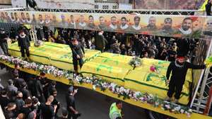 epa12904831 People gather around coffins of Hezbollah fighters, who were killed before the ceasefire between Hezbollah and Israel, during a mass funeral procession in Kfar Sir village, southern Lebanon, 21 April 2026. Hezbollah announced in a statement it will hold a mass funeral in Kfar Sir for 29 people killed in the conflict with Israel before the 10-day ceasefire took effect.  EPA/WAEL HAMZEH