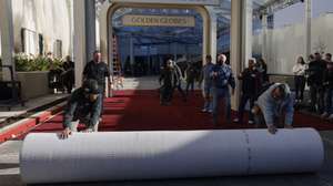 epa11802616 Workers roll out the red carpet as preparations for the 82nd Golden Globe Awards get underway at the Beverly Hilton in Beverly Hills, California, USA, 02 January 2025. The 82nd Golden Globe Awards will take place at the Beverly Hilton on 05 January 2025.  EPA/CAROLINE BREHMAN