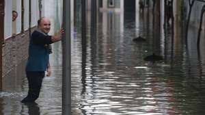 epa13313479 A resident looks at a flooded street after heavy rainfall that hit the area early in the morning, in the town of Algeciras, southern Spain, 18 October 2026.  EPA/A.Carrasco Ragel
