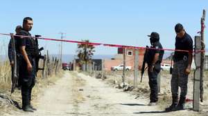 epa11957462 Members of the state prosecutor's office guard Izaguirre Ranch, where the Guerreros Buscadores collective located clandestine crematoriums on 05 March 2025 in the municipality of Teuchitlan, Jalisco, Mexico 11 March 2025. The search group for missing persons discovered three clandestine crematoriums, along with charred and crushed human bones, more than 200 pairs of shoes, and hundreds of items of clothing, on a property attributed to one of the drug cartels.  EPA/FRANCISCO GUASCO