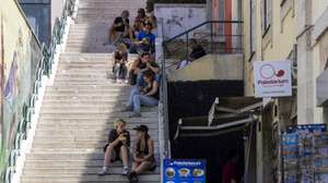 People take shelter from the sun, downtown Lisbon, Portugal, 02 July 2026. The national weather agency (IPMA) has issued high-level red alerts due to a spell of extreme heat that is expected to last for at least a week. JOSE SENA GOULAO/LUSA