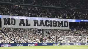 epa12776891 Real Madrid fans hold a banner with the slogan 'No to racism' during the Champions League play-offs second leg soccer match between Real Madrid and Benfica in Madrid, Spain, 25 February 2026.  EPA/SERGIO PEREZ