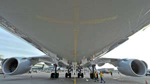 epa03027948 A photo taken with a super wide-angle lens shows employees of the airport being dwarf by the fuselage of a Boeing 747-8 Intercontinental at a gate of the airpot in Frankfurt Main, Germany, 08 December 2011. The aircraft is currently positioned in Frankfurt to be tested and examined, before it is  taken into regular services of German air carrier Lufthansa.  EPA/BORIS ROESSLER