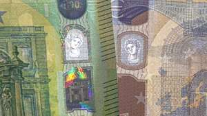 epa07589196 An image showing the new 100 euro and 200 euro banknotes with their security details visible during their presentation by the Deutsche Bundesbank, German central bank, in Frankfurt Main, Germany, 21 May 2019.  EPA/ARMANDO BABANI