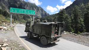 epa08658802 Indian army vehicles move along a highway leading to Ladakh, at Gagangeer some 81 kilometers from Srinagar, the summer capital of Indian Kashmir, 07 September 2020 (issued 10 September 2020). Apart from nomadic families with goats, sheep and horses, no one is allowed to travel along the normally bustling mountain road to allow the Indian military to operate freely amid a months-long standoff between India and China along the disputed border in eastern Ladakh.  EPA/FAROOQ KHAN