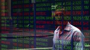 epa08365496 A man walks past digital market boards at the Australian Stock Exchange (ASX) in Sydney, Australia, 16 April 2020. Crown Resorts has stood down 11,500 employees - 95 percent of its staff - because of the coronavirus restrictions affecting its casinos in Melbourne and Perth, but it still will pay shareholders their interim dividend.  EPA/JOEL CARRETT AUSTRALIA AND NEW ZEALAND OUT