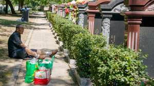 epa10828047 An elderly man sits beside tombs at a cemetery in Beijing, China, 30 August 2023. The Hungry Ghost Festival, also known as the Zhongyuan Festival, is a traditional Taoist and Buddhist festival held in certain East Asian countries. According to the Chinese calendar, the Ghost Festival is on the 15th of the seventh month, in which living descendants pay homage to their deceased ancestors.  EPA/WU HAO