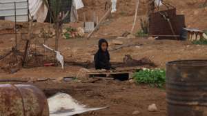 epa12658443 A Palestinian child watches his family dismantle their tents and sheet metal structures, used for shelter and livestock farming, and preparing to leave the area due to increasing attacks by Israeli settlers near  Jericho, West Bank, 18 January 2026. According to the Palestinian news agency Wafa, 33 Palestinian families are leaving the Bedouin community of Shallal Al-Auja north of Jericho, due to the attacks by Israeli settlers, bringing the total number of families forcibly displaced from the community to 79.  EPA/ALAA BADARNEH