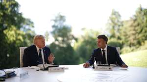 epa13039738 French President Emmanuel Macron (R) and US President Donald Trump (L) attend a working dinner at the Hotel Royal during the G7 summit in Evian-les-Bains, France, 15 June 2026. The 52nd G7 Summit takes place in Evian-les-Bains from 15 to 17 June 2026.  EPA/YOAN VALAT