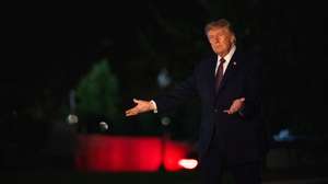 epa13278005 United States President Donald Trump motions to new pavement as he arrives on the South Lawn in Washington, DC, USA, 02 October 2026.  EPA/Annabelle Gordon / POOL