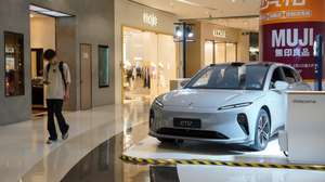 epa11407063 A man walks beside a NIO ET5 electric car on display in a shopping mall in Beijing, China, 13 June 2024. Beijing urges the European Union to reconsider tariffs on Chinese electric vehicles and to stop going further in what they say is the 'wrong direction' to protect its auto industry from competition, according to China's state news agency Xinhua. China said it would take measures to safeguard its interests after the European Commission announced on 12 June it would impose extra duties of up to 38.1 percent on imported Chinese electric vehicles from July 2024.  EPA/WU HAO