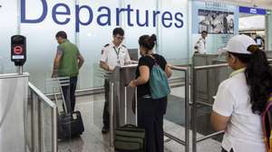 epa07772454 Passengers have their passport checked at departure gates in Hong Kong International Airport, Hong Kong, China, 14 August 2019. Flights were departing largely on schedule a day after pro-democracy protesters caused chaos with a disruptive sit-in that paralyzed the busy transport hub. The Airport Authority said it had been granted an injunction order to ban anyone from illegally or intentionally disrupting the normal usage of the airport.  EPA/MIGUEL CANDELA
