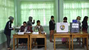 epaselect epa12615110 Voters line up to vote with an Electronic Voting Machine during the first phase of general election at a polling station in Naypyitaw, the capital city of Myanmar, 28 December 2025. The State Administration Council (SAC), Myanmar's military government, will hold its first national vote since the February 2021 coup in a multi-stage general election, with the first phase scheduled for 28 December 2025 and the second for 11 January 2026. Over 50 political parties have registered to participate in the election, according to the Union Election Commission (UEC). The government dissolved the main pro-democracy opposition, the National League for Democracy (NLD), in March 2023.  EPA/RUNGROJ YONGRIT
