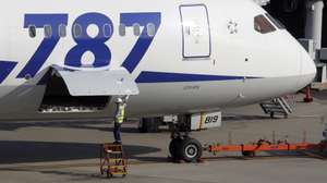 epa08967894 (FILE) - A member of ground staff of All Nippon Airways Co. closes a door near the battery room of a Boeing 787 Dreamliner before departure at Tokyo International Airport at Haneda, Tokyo, Japan, 30 October 2013 (reissued 26 January 2021). Boeing is due to release its 4th quarter 2020 results on 27 January 2021.  EPA/KIMIMASA MAYAMA *** Local Caption *** 56327701